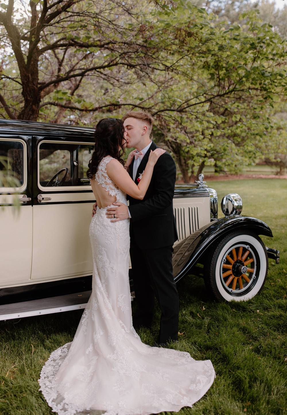 Bride and groom posing with a classic car included for photo opportunities at On Collin's Pond, Middleton, Idaho